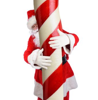 Santa Claus with his arms wrapped around a giant Candy Cane, isolated on white.