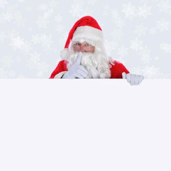 Santa Claus with blank sign making shhh sign with finger in front of face with a light silver background with snow flakes.