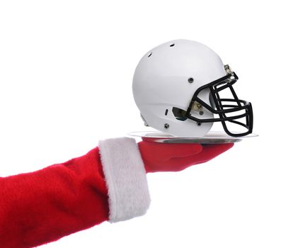 Santa Claus holding a serving tray with an american football helmet, over white.