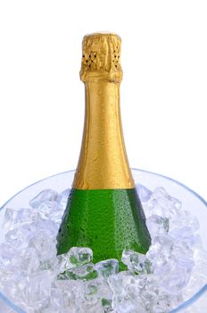 Closeup of a Champagne bottle in a crystal ice bucket. Vertical format over a white background.
