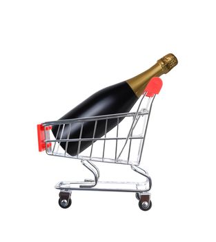 A Champagne bottle inside a grocery store shopping cart, isolated on white.