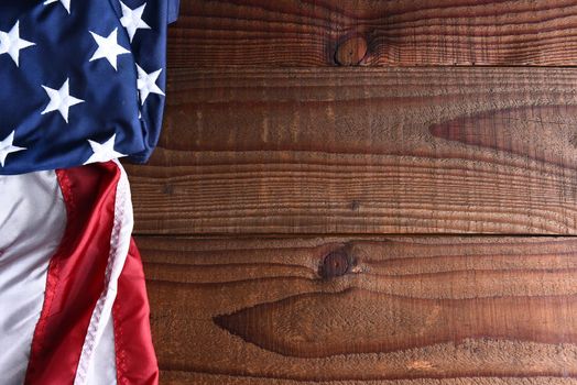 Closeup of an American flag on a dark wood table with copy space. 