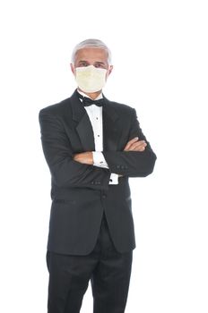 Mature Adult Male Wearing a Tuxedo and a Covid-19 protective mask with arms folded in front of body isolated on white
