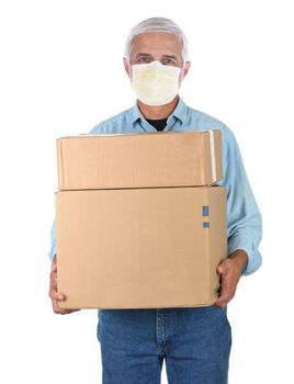 Deliveryman wearing covid-19 mask carrying two cardboard boxes isolated on white.