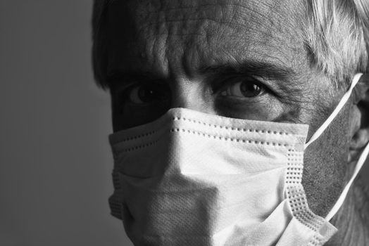 Closeup of a man wearing a Covid-19 protective face mask during the Coronavirus pandemic.