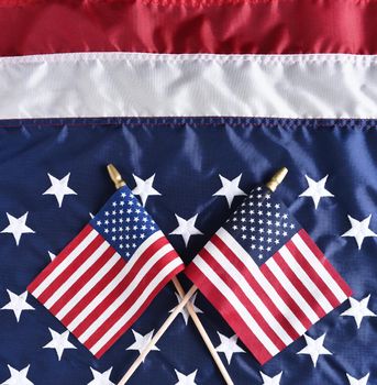 Two small American Flags on a larger Flag. Top view in square format.