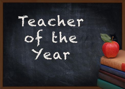 Teacher of the Year written on chalkboard with a stack of books and red apple 