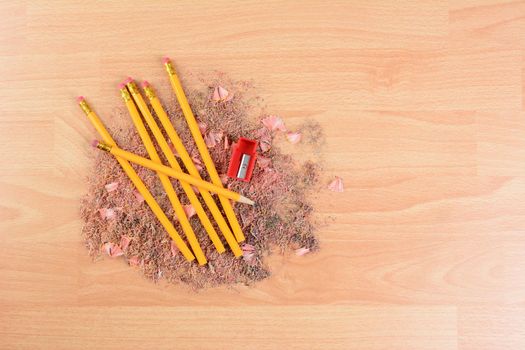 High angle view of yellow number 2 pencils on a school desk with a sharpener and shavings. Horizontal with copy space. Back to school concept.