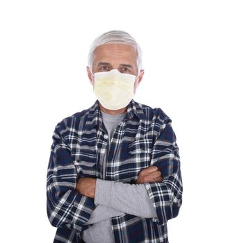 Senior man with arms folded wearing a Covid-19 protective mask isolated over white.