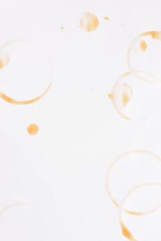 Coffee ring stains and drips on white paper, with copy space.