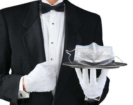 A tuxedo wearing waiter holding a silver tray With A COVID-19 mask. Horizontal format on white.