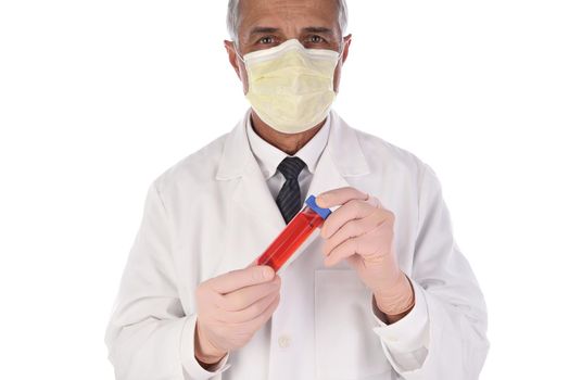 Laboratory Technician holding a vial of red liquid in front of his body. Man is wearing a protective mask to prevent infection. 
