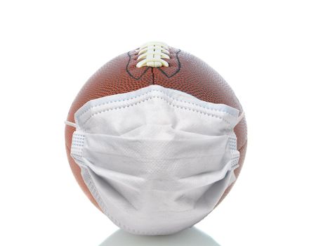 Sports and Covid-19 Concept.  End shot of an american Foortball with a surgical mask.