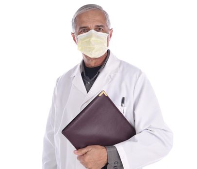 Portrait of a middle aged doctor wearing a surgical mask and lab coat holding a notebook under his arm. Isolated on white.