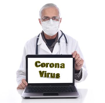 Coronavirus in large letters on a laptop computer screen. A Medical professional in surgical mask and lab coat is behind the computer.