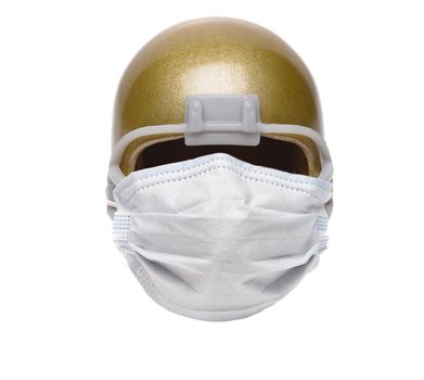Sports and Covid-19 Concept.  An american Foortball Helmet with a surgical mask. 