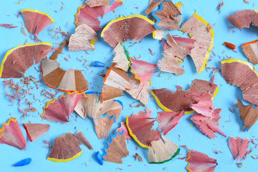 Flat lay closeup of pencil shavings on a blue background, Back to School Concept. 