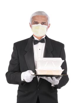 Butler in tuxedo wearing a covid-19 protective face mask holding a take-out food containers on a tray, isolated over white