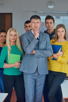 group portrait of teacher with students in shcool classrom