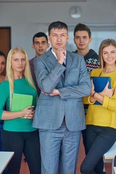 group portrait of teacher with students in shcool classrom