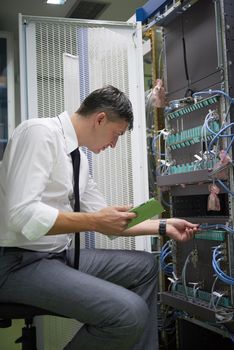 network engineer working in  server room, corporate business man working on tablet computer