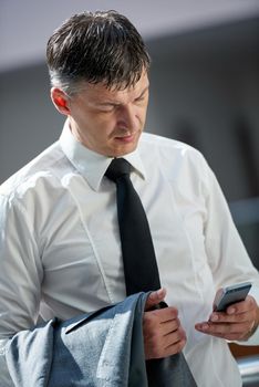 business man using phone at modern office space