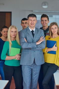 group portrait of teacher with students in shcool classrom