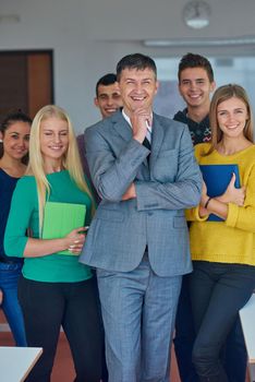 group portrait of teacher with students in shcool classrom