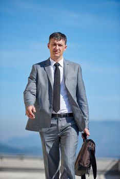 urban outdoor portrait of middle aged senior  business man