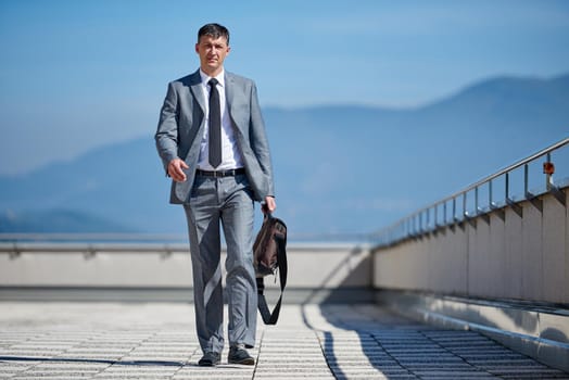 urban outdoor portrait of middle aged senior  business man