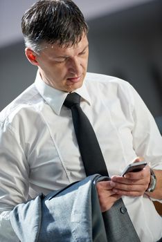 business man using phone at modern office space