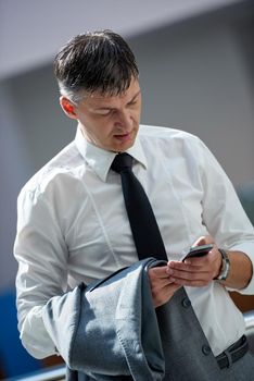 business man using phone at modern office space