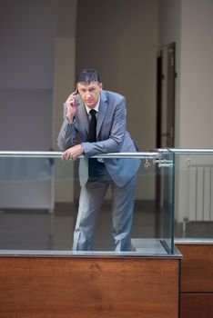 business man using phone at modern office space