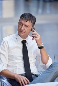 business man using phone at modern office space