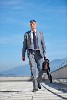 urban outdoor portrait of middle aged senior  business man