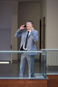 business man using phone at modern office space