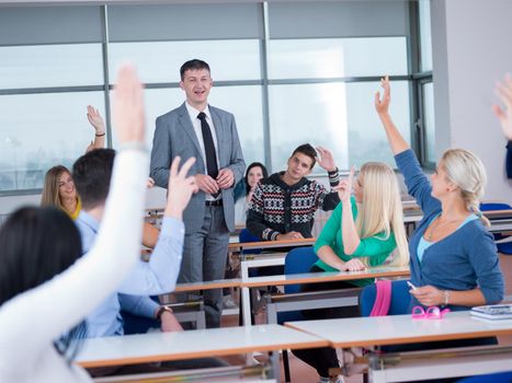 group of students with teacher in computer lab classrom learrning lessons,  get help and support