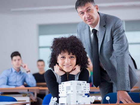 group of students with teacher in computer lab classrom learrning lessons,  get help and support