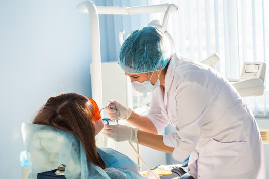 Woman at the dentist's chair during a dental procedure.