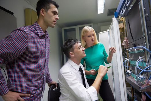 business people group, network engeneers working in network server room on tablet computer