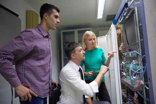 business people group, network engeneers working in network server room on tablet computer