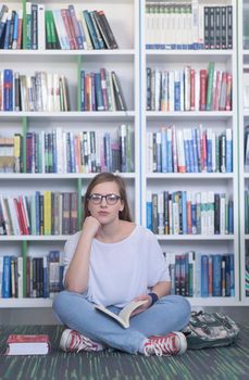 smart looking famale student girl  in collage school library reading book