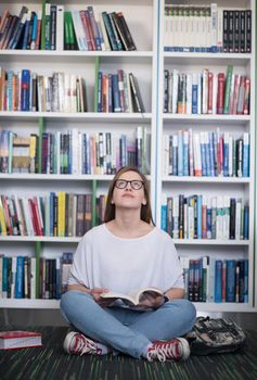 smart looking famale student girl  in collage school library reading book