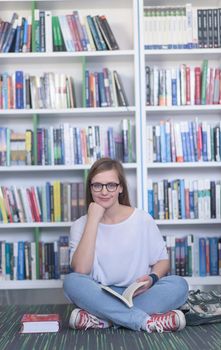 smart looking famale student girl  in collage school library reading book