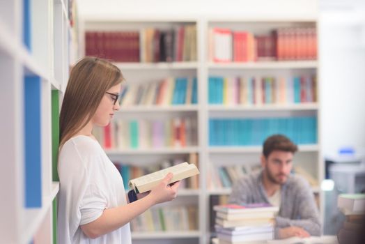 happy students couple in school  library have discussion about book