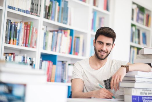 Student reading book in school library. Study lessons for exam. Hard worker and persistance concept.