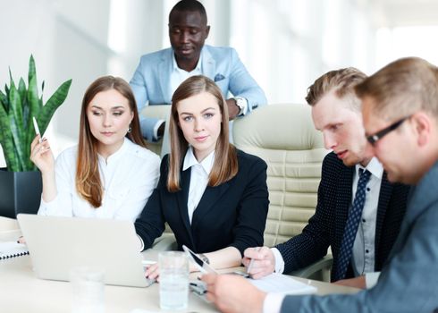 Image of business partners discussing documents and ideas at meeting