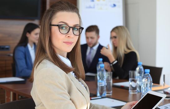 business woman with her staff, people group in background at modern bright office indoors.