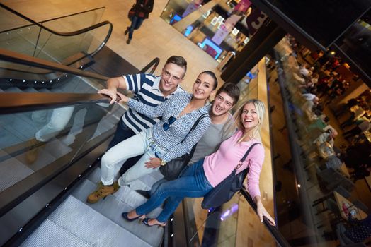 group of happy  friends in shopping mall have fun