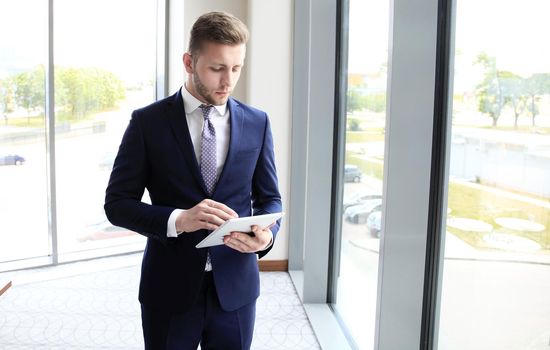 Businessman using his tablet in the office.